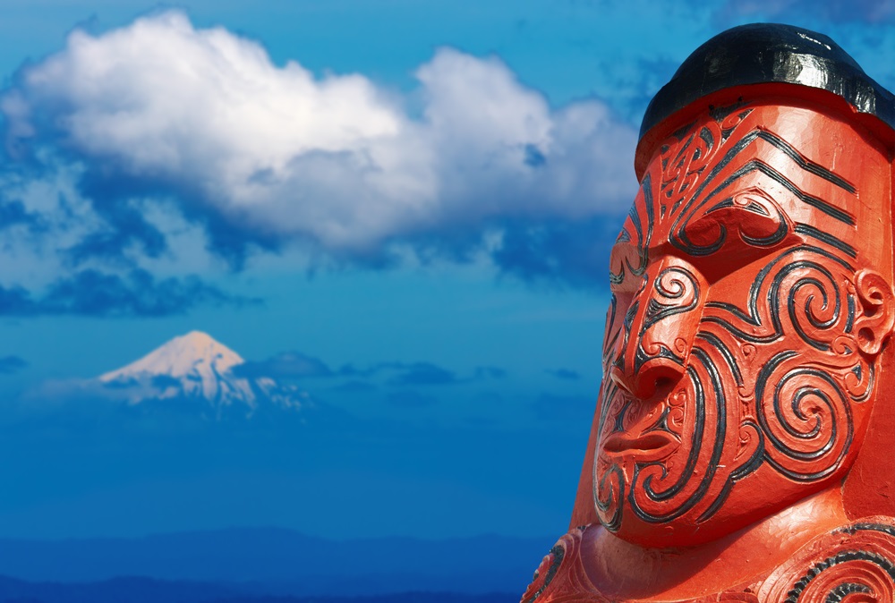 Traditional maori carving over Taranaki Mount background, New Zealand